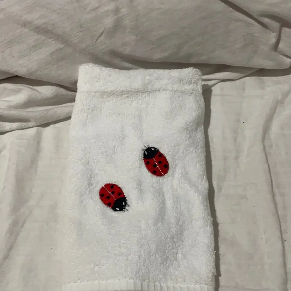 Priapos Home white hand towel with2 embroidered lady bugs NWT and super cute